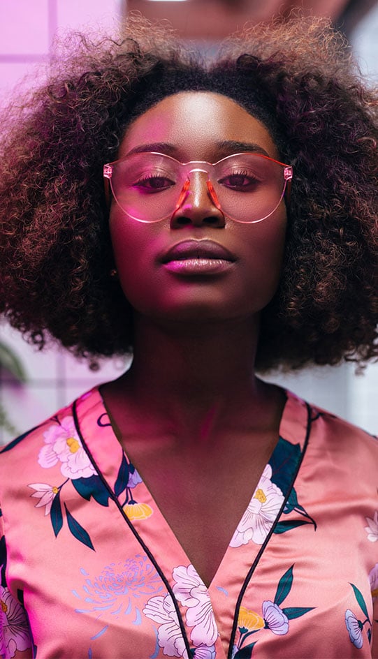 Woman with glasses looking at camera